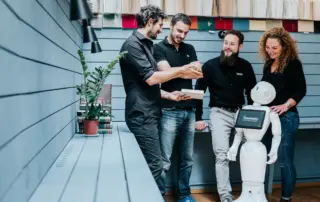 Humanizing technologies, employees pictures with Pepper